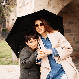 Mother and child under umbrella in Icherisheher Old City Baku during family photo session