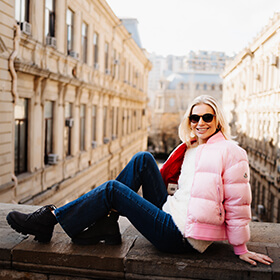 Woman sitting on historic wall in Icherisheher Old City Baku during a street photo session